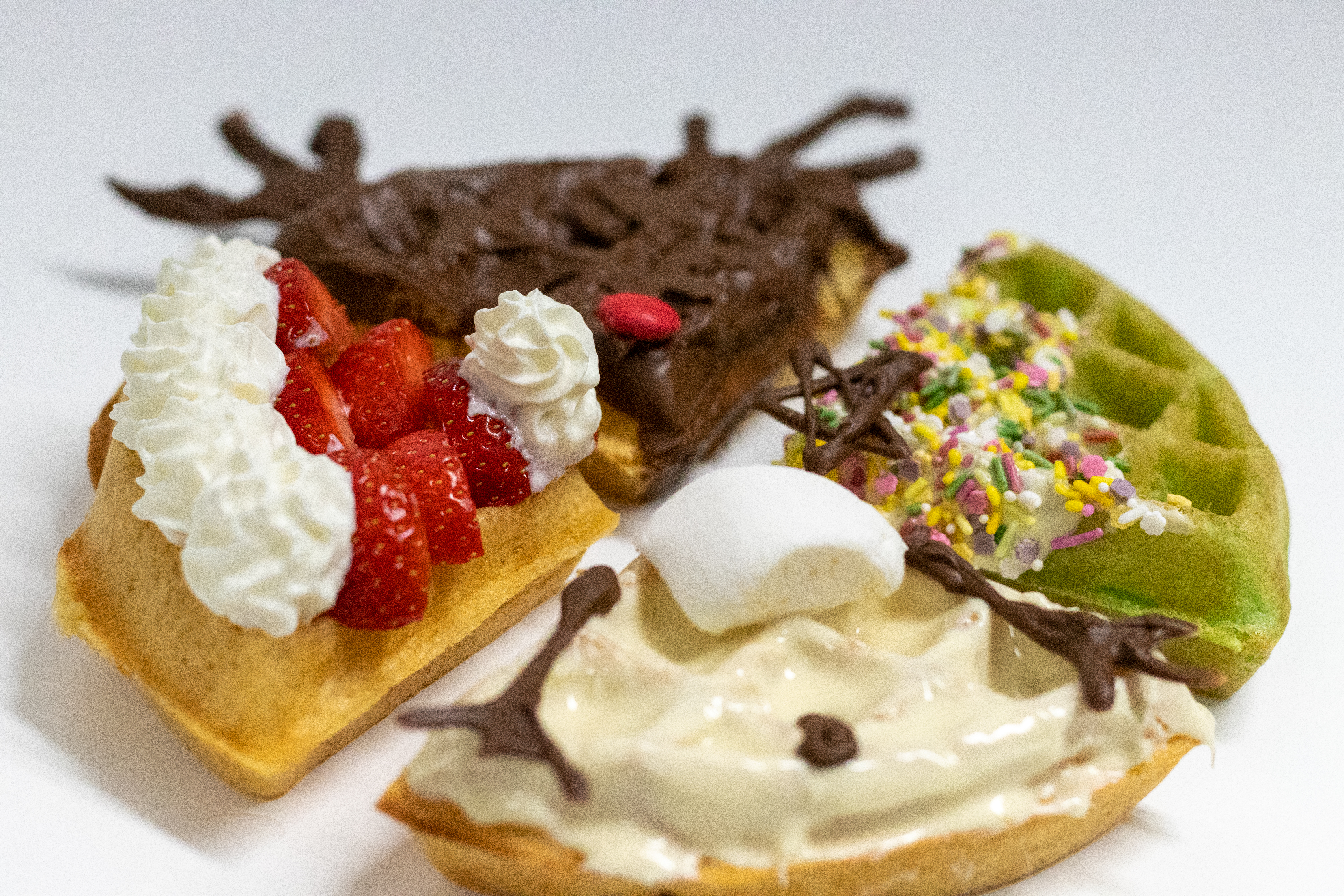 Christmas waffle quarters decorated with different festive flavours and toppings.